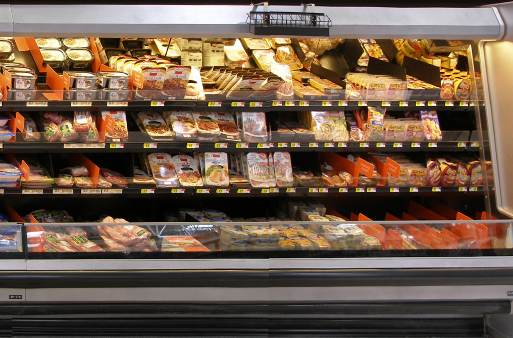 A grocery store refrigerated display case after being refreshed by Marco