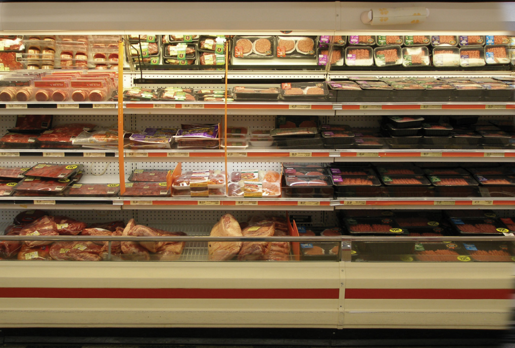 An old outdated refrigerated grocery store display wall