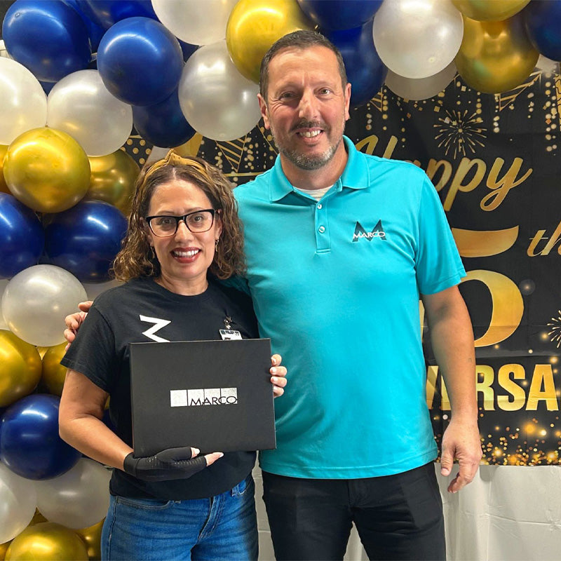 Marco Company team members stand together accepting an award